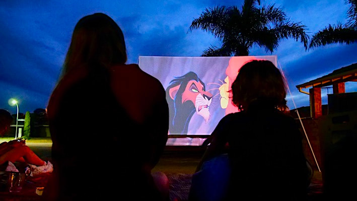 High definition image of the Lion King being projected onto an outdoor cinema screen.